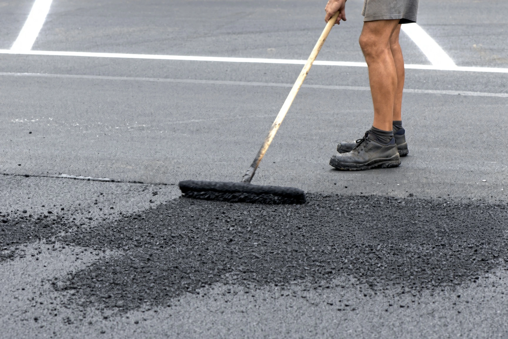 Asphalt milling machine resurfacing a retail parking lot in Plano Texas